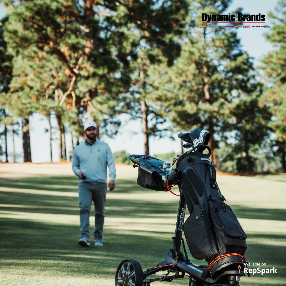 Man walking on a golf course with a car bag next to him.