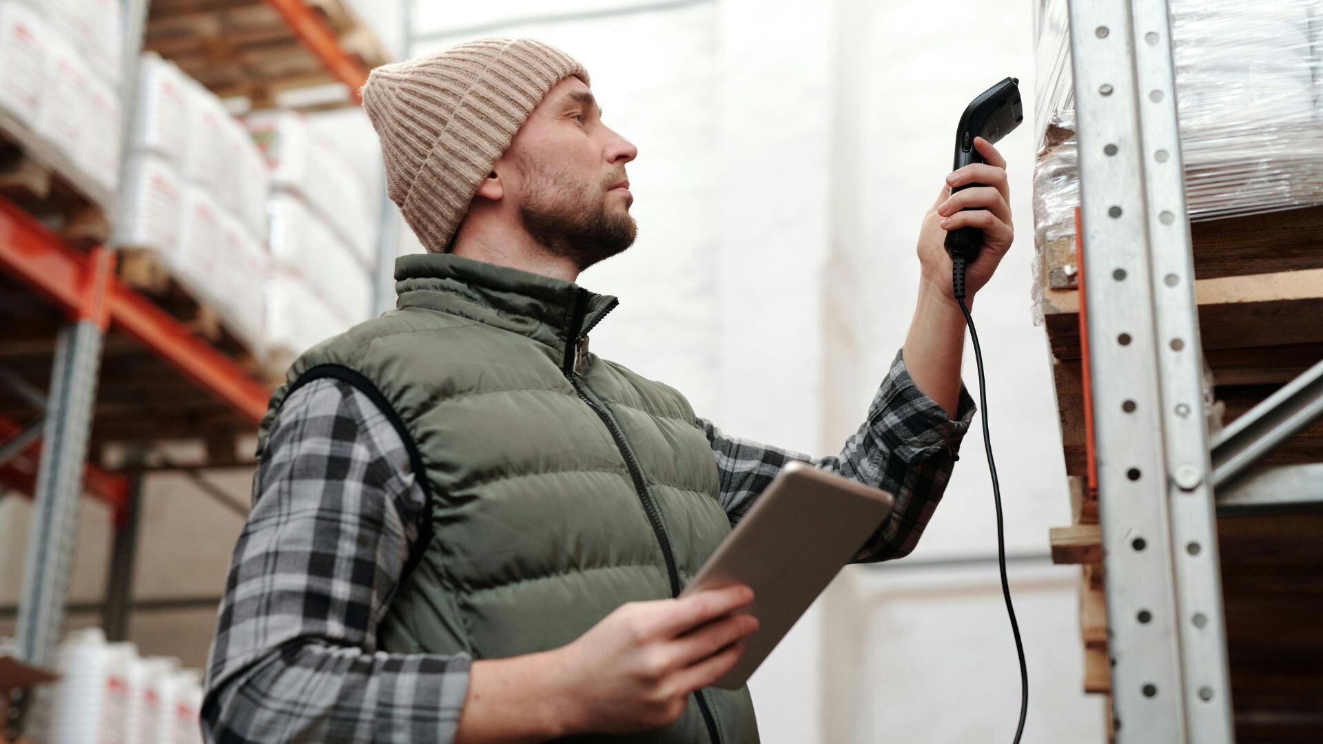 a man scanning product with the use of technology for his wholesale business