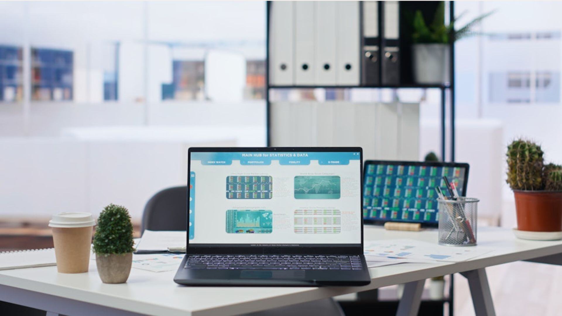 laptop centered on a table with forecast demand charts on the screen