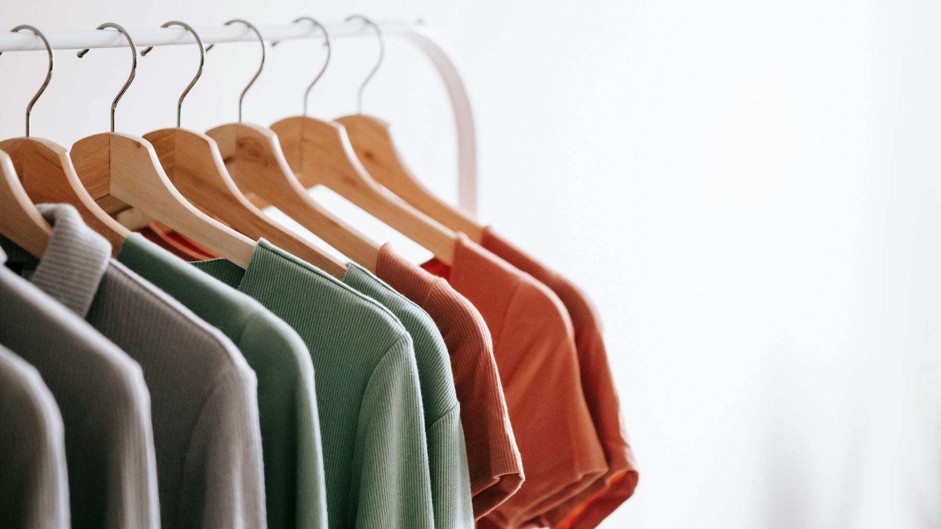 several shirts hung on a rack with coat hangars for a blog to prevent stockouts